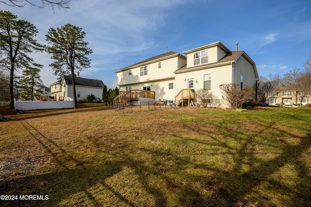 back of house with a lawn