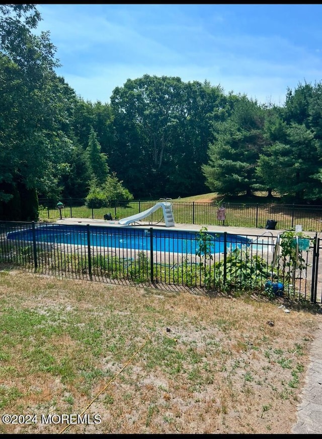 view of swimming pool featuring a water slide