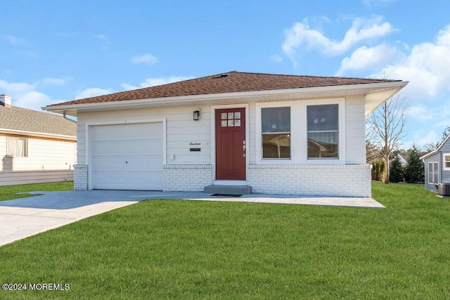 view of front of house featuring a garage, a front lawn, and central air condition unit