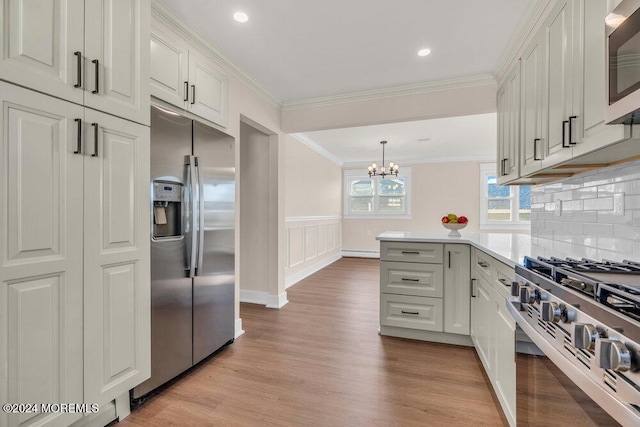 kitchen featuring white cabinetry, appliances with stainless steel finishes, and crown molding