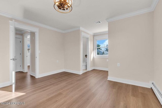 spare room with an inviting chandelier, crown molding, a baseboard radiator, and light wood-type flooring