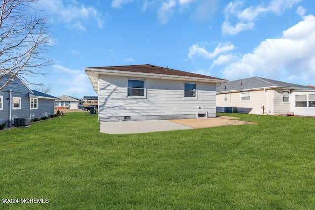 rear view of house with a patio, a yard, and central air condition unit