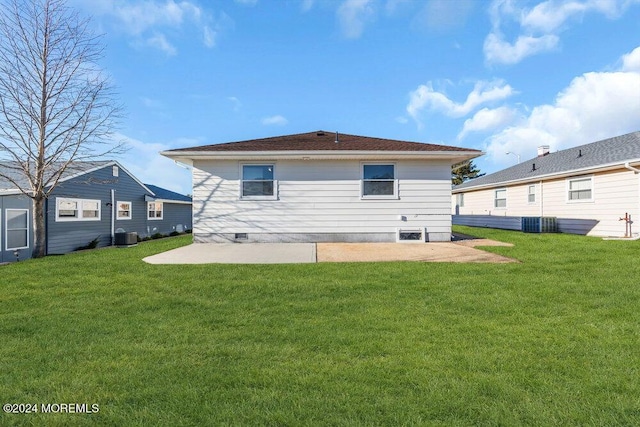 rear view of house with a yard, central AC, and a patio