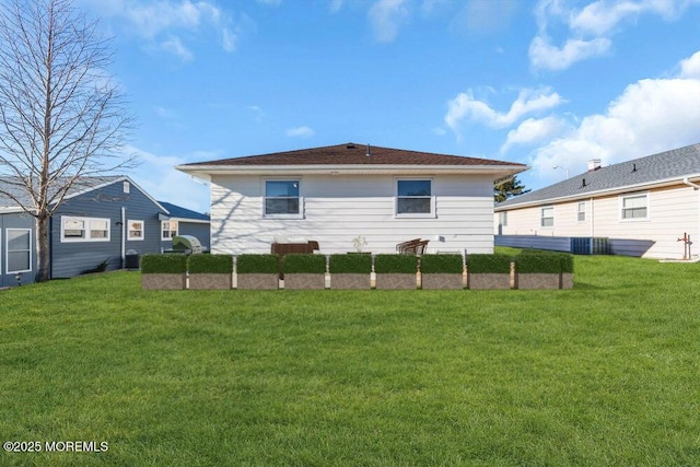 rear view of house featuring a yard