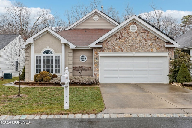 view of front facade featuring central AC unit, a garage, and a front yard