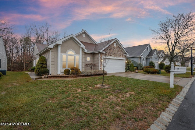 view of front of house with a yard and a garage