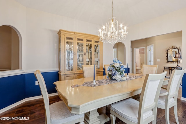 dining space featuring dark hardwood / wood-style flooring and a notable chandelier