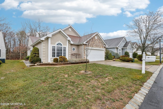 view of front of house with a garage and a front yard