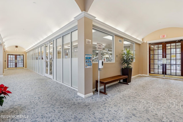 corridor with carpet, french doors, and lofted ceiling