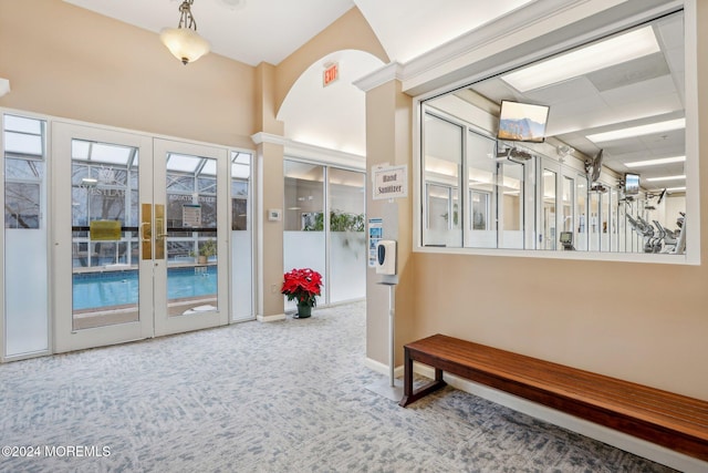 hallway featuring plenty of natural light, carpet floors, and french doors