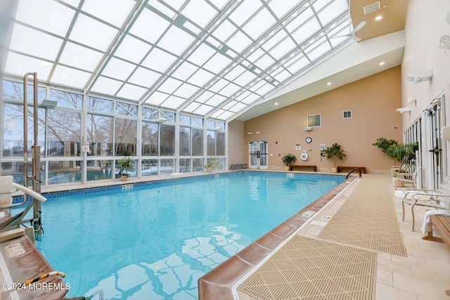 view of swimming pool with a lanai and a patio