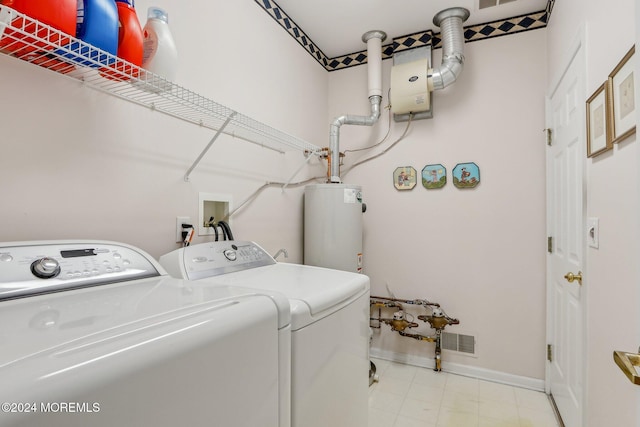 laundry area featuring washing machine and clothes dryer and gas water heater