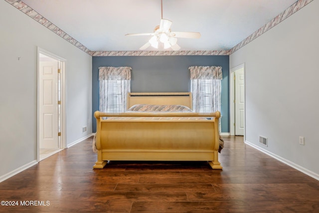 bedroom featuring multiple windows, dark wood-type flooring, and ceiling fan