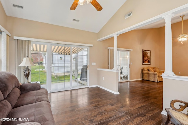 living room with ceiling fan, ornate columns, dark wood-type flooring, and high vaulted ceiling