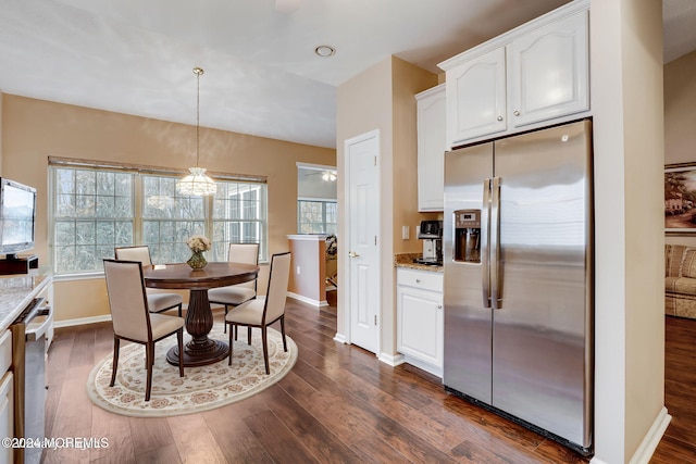 dining room with dark hardwood / wood-style floors, plenty of natural light, and ceiling fan