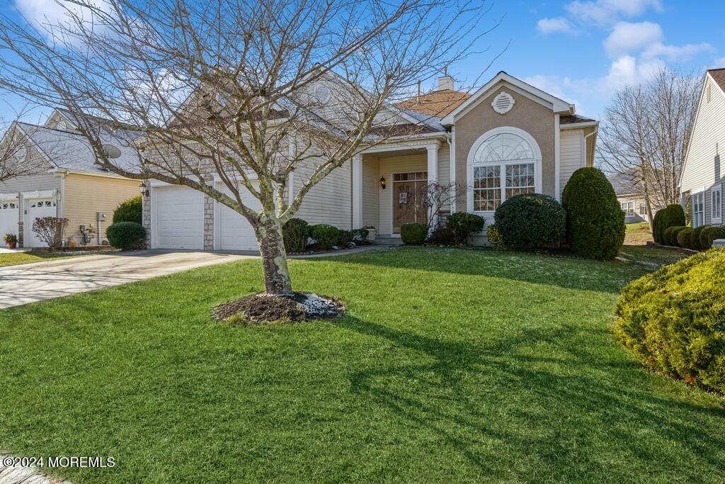 view of front of house featuring a garage and a front lawn