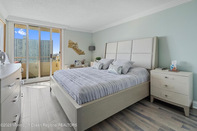 bedroom with access to exterior, expansive windows, ornamental molding, a textured ceiling, and hardwood / wood-style flooring