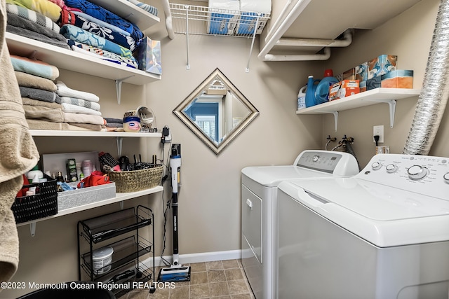 laundry area with washing machine and dryer and light tile patterned floors