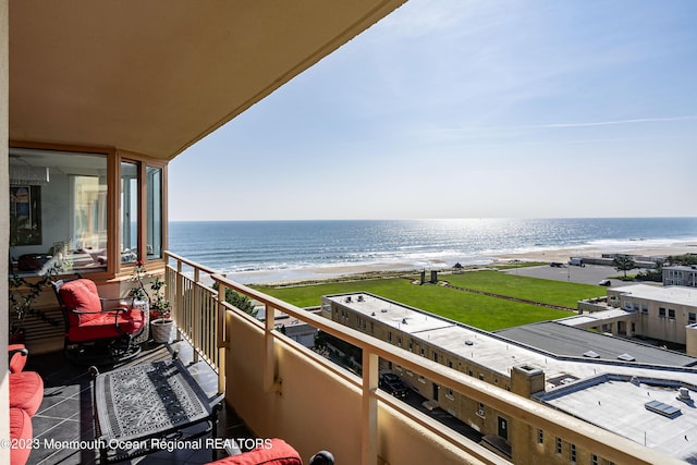 balcony with a view of the beach and a water view