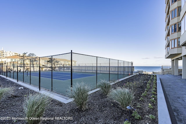 view of sport court with a water view