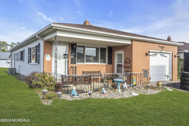 ranch-style house featuring a porch, cooling unit, a front yard, and a garage