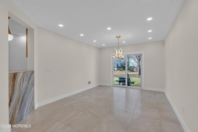 unfurnished room with a chandelier