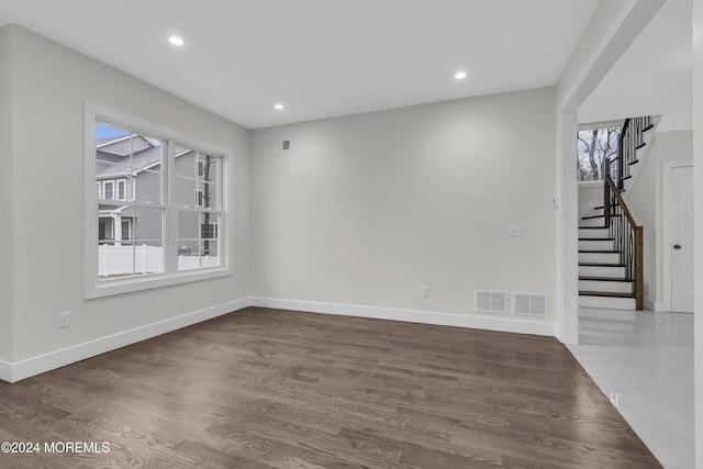 spare room with dark wood-type flooring