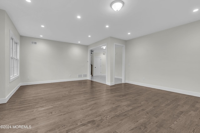 spare room featuring wood-type flooring