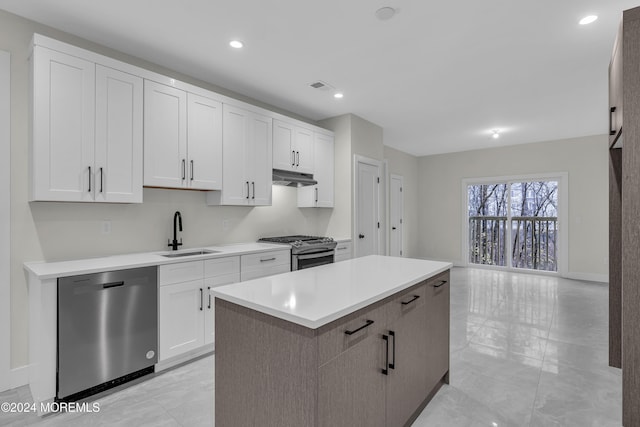 kitchen with white cabinetry, sink, a center island, and stainless steel appliances