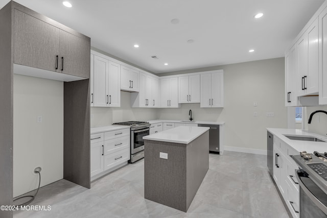 kitchen with white cabinetry, sink, a kitchen island, and stainless steel appliances