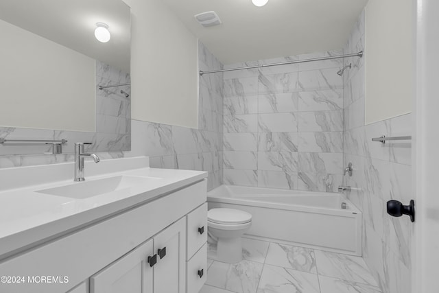 full bathroom featuring vanity, toilet, tile walls, and tiled shower / bath combo