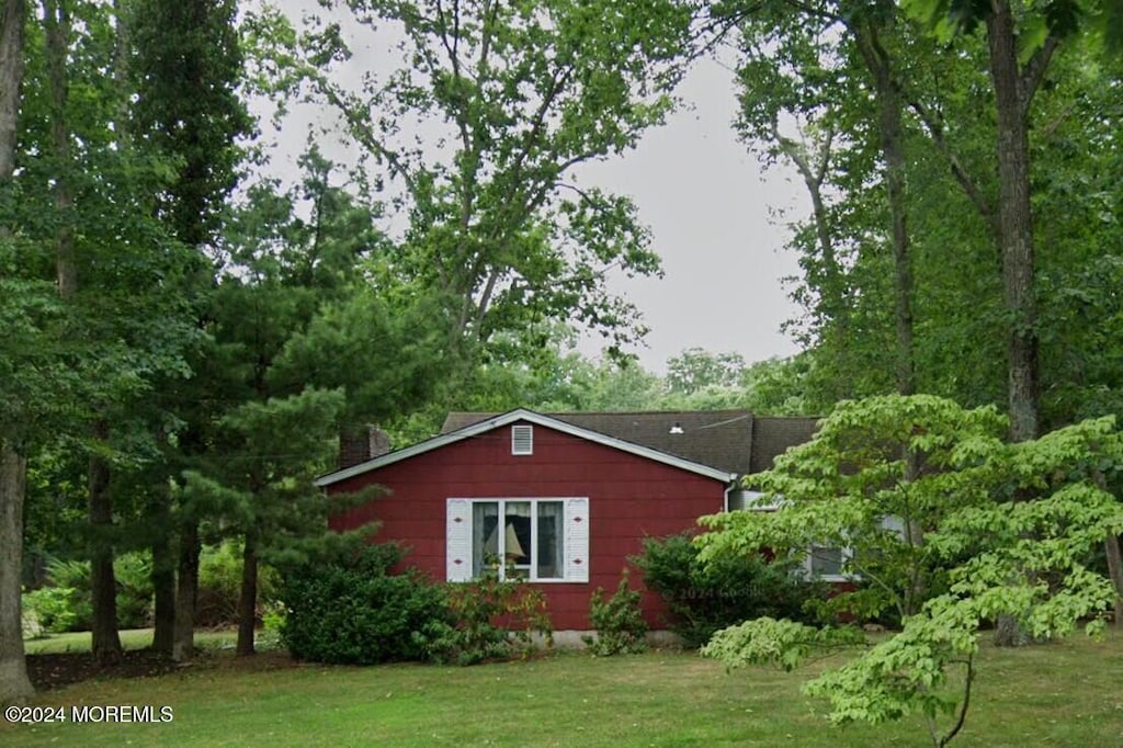 view of home's exterior with a yard