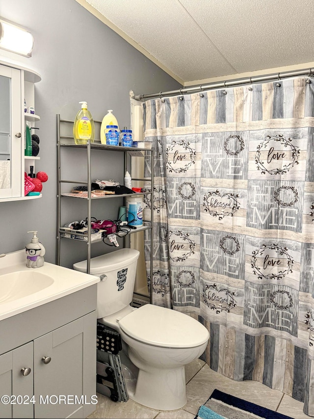 bathroom with tile patterned floors, vanity, toilet, and a textured ceiling