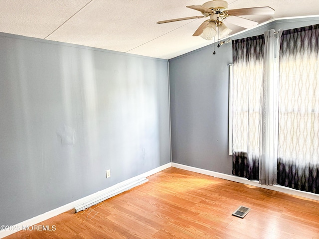 8 Monique Cir, Hazlet, NJ 07730 - spare room with a textured ceiling, light wood-style flooring, visible vents, ceiling fan, and baseboards