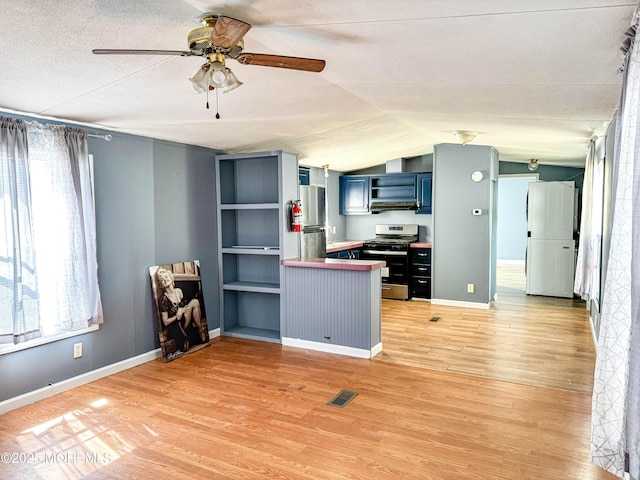 8 Monique Cir, Hazlet, NJ 07730 - kitchen featuring blue cabinetry, visible vents, stainless steel gas range, a ceiling fan, and a peninsula