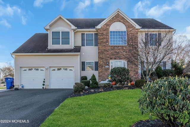 view of front facade featuring a front yard and a garage