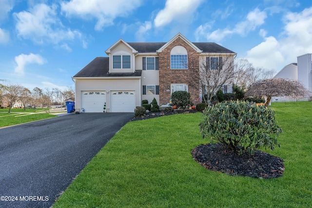 view of front of property with a garage and a front lawn