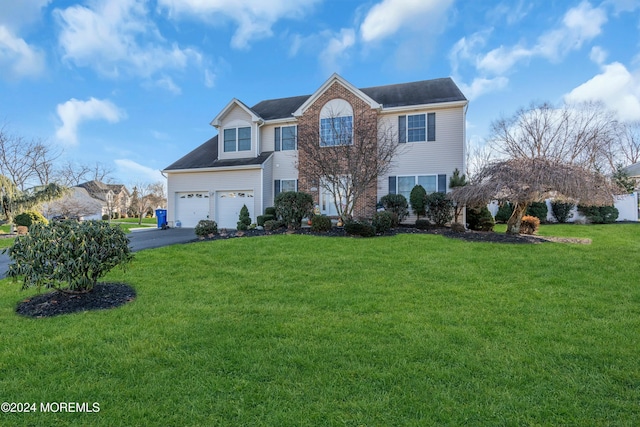 view of front of house with a front yard and a garage