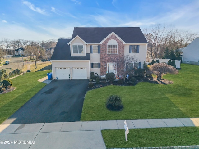 view of front of home with a garage and a front yard