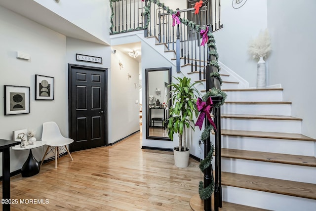 entrance foyer with a high ceiling and light wood-type flooring