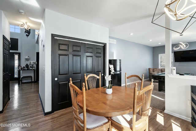 dining room featuring dark hardwood / wood-style flooring, a notable chandelier, and pool table