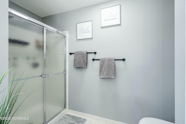 bathroom featuring tile patterned floors and an enclosed shower