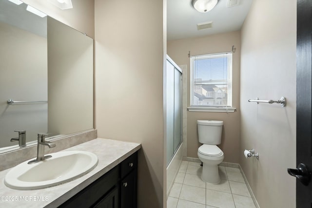 full bathroom featuring tile patterned flooring, vanity, bath / shower combo with glass door, and toilet