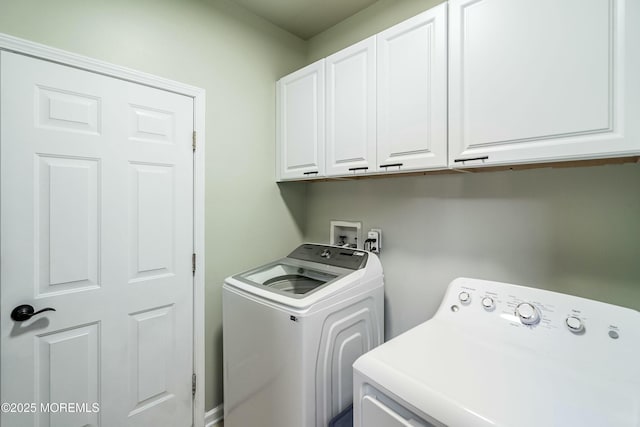 laundry area with cabinets and washer and clothes dryer