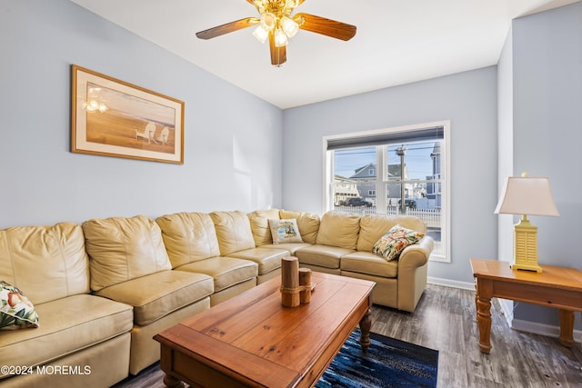 living room featuring ceiling fan and dark wood-type flooring