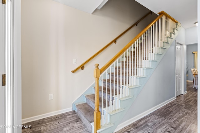 stairs featuring hardwood / wood-style floors