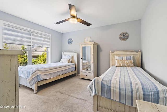 bedroom with light carpet and ceiling fan