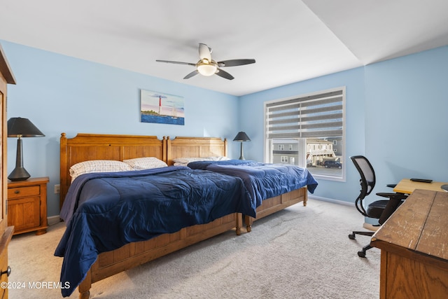 bedroom with ceiling fan and light carpet