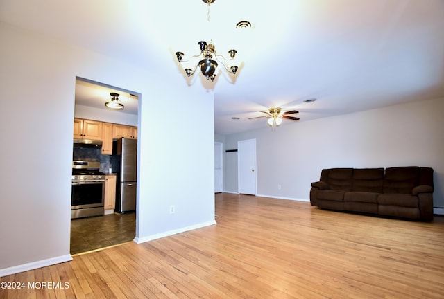 unfurnished living room with ceiling fan and light hardwood / wood-style flooring