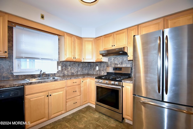 kitchen featuring appliances with stainless steel finishes, backsplash, light brown cabinetry, and sink